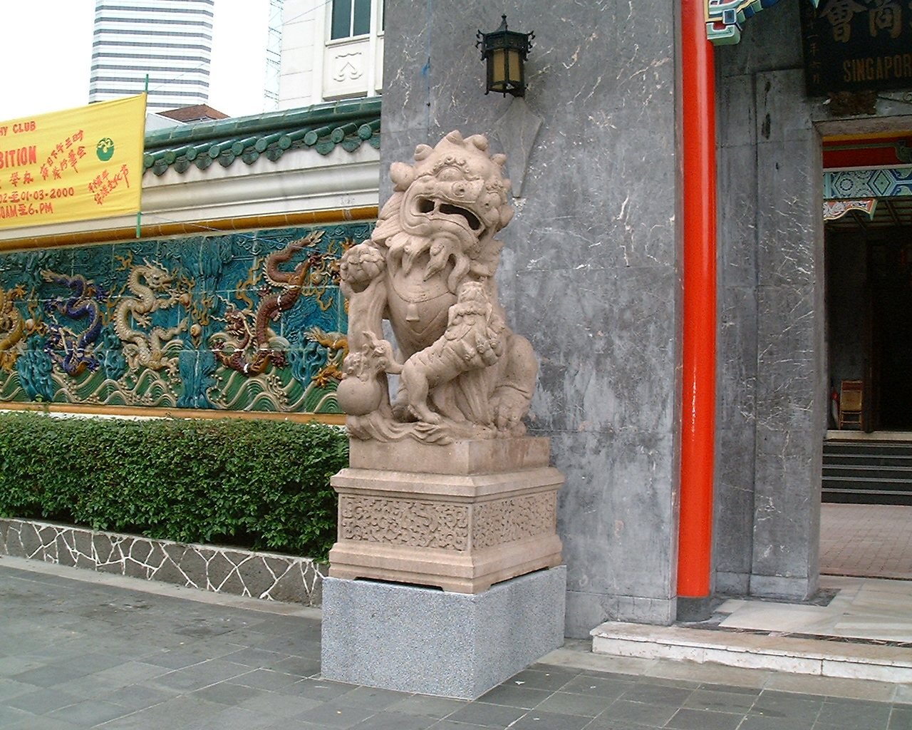 Close-up view of the lion guardian on the right side of the main gate