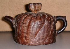 Clay tea pot which looks like a `meshed' screen.